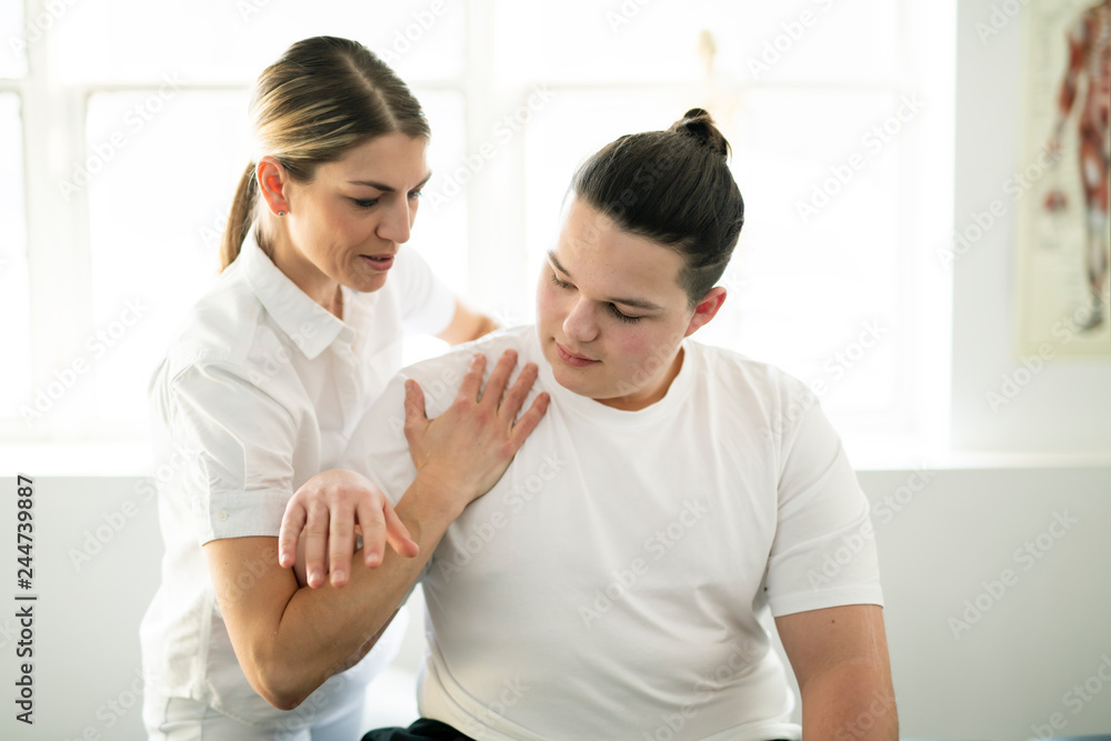 A Modern rehabilitation physiotherapy woman worker with client A Modern rehabilitation physiotherapy woman worker with client