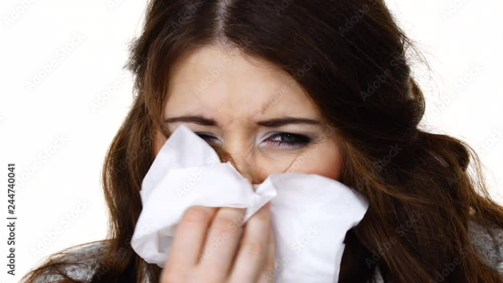 Sick freezing woman sneezing in tissue. Girl wearing warm sweater being cold and trembling. Seasonal diseases flu or other virus. Health care. Isolated Sick freezing woman sneezing in tissue. Girl wearing warm sweater being cold and trembling. Seasonal diseases flu or other virus. Health care. Isolated