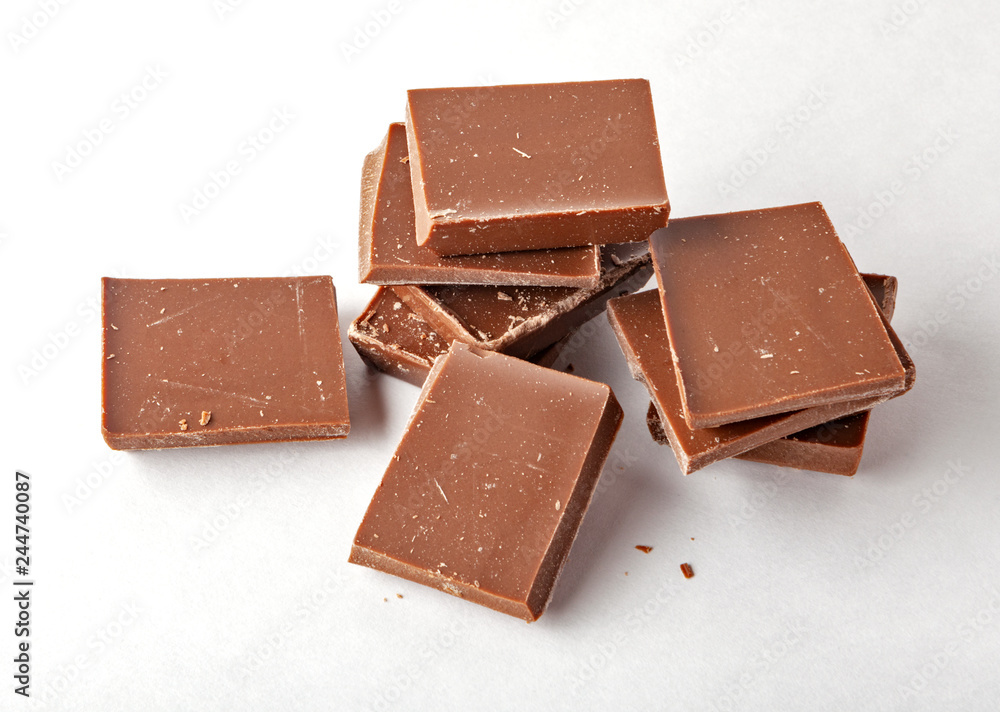 Chocolate tablets and broken pieces isolated on white background. Chocolate tablets and broken pieces isolated on white background.
