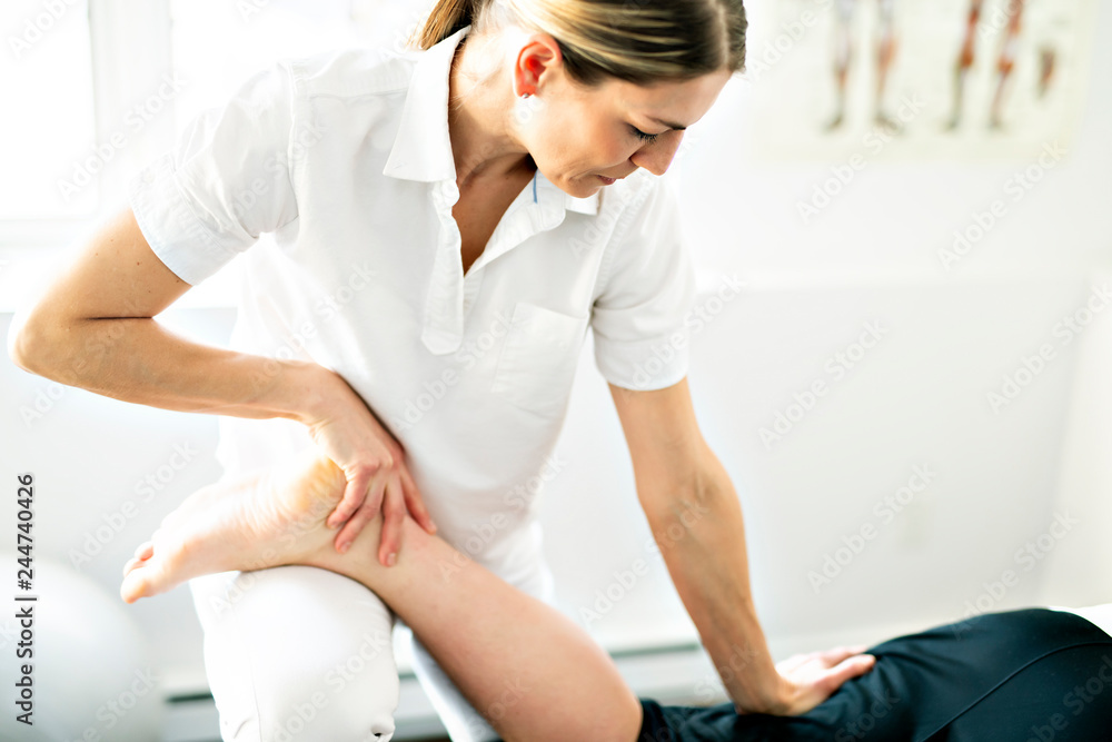 A Modern rehabilitation physiotherapy woman worker with client A Modern rehabilitation physiotherapy woman worker with client