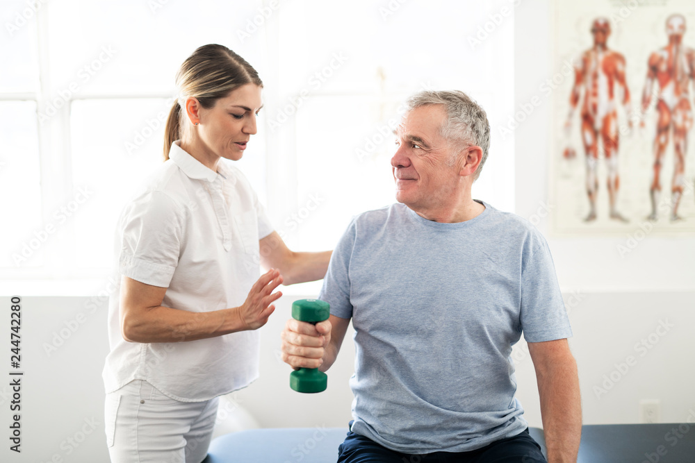 A Modern rehabilitation physiotherapy worker with senior client A Modern rehabilitation physiotherapy worker with senior client