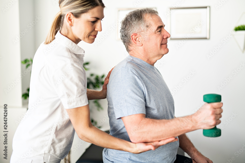 A Modern rehabilitation physiotherapy worker with senior client A Modern rehabilitation physiotherapy worker with senior client