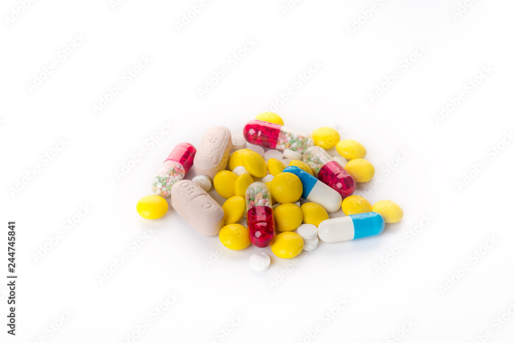 Background of assorted pharmaceutical capsules and medication in different colors,