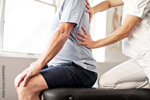 A Modern rehabilitation physiotherapy worker with senior client photo