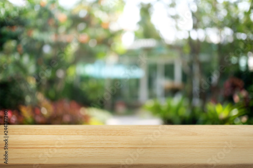 empty wood table over blurred outdoor cafe background