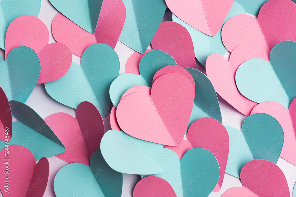 Valentine's Day background made of paper hearts. Heart shape texture. Top view