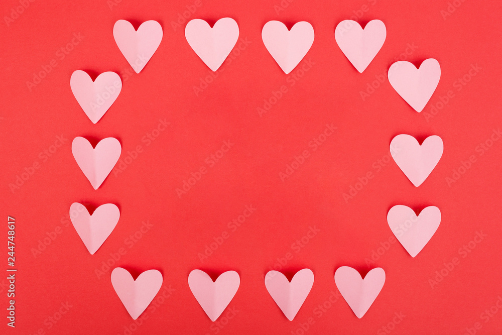 Flat lay of paper hearts frame on red background. Top view. Flat lay. Valentine's Day concept