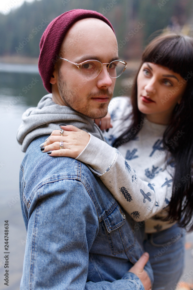 Young couple hugging on stone near the lake. stand against the background of the rocks. Top view. Nature. Young couple hugging on stone near the lake. stand against the background of the rocks. Top view. Nature.