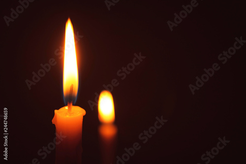 Candle lit in the dark, Candle flame at night. Lighting design for background.