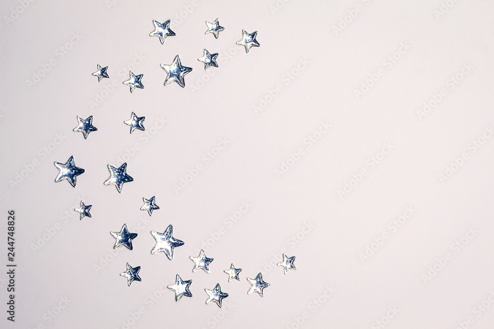 Beautiful Crescent concept made of shining silver stars with embossed transparent top on white background. Copy space. Top view. Beautiful Crescent concept made of shining silver stars with embossed transparent top on white background. Copy space. Top view.