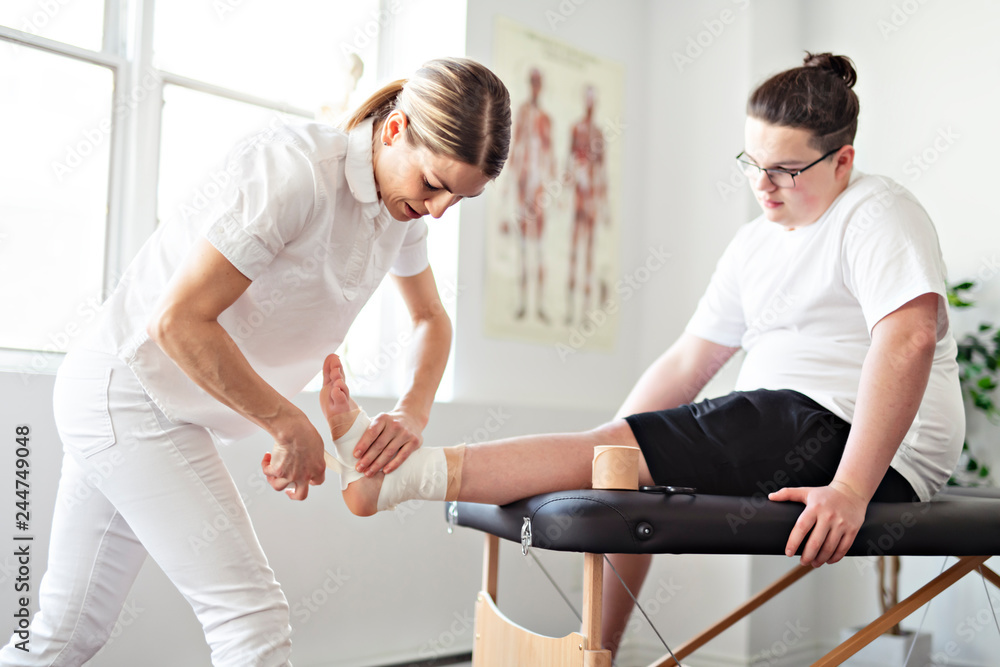 A Modern rehabilitation physiotherapy woman worker with client A Modern rehabilitation physiotherapy woman worker with client