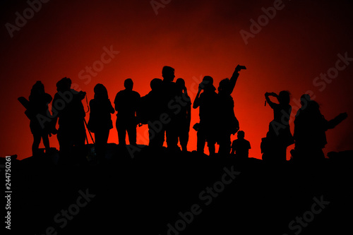 Unrecognized Tourists's silhouettes on Erta Ale Volcano edge illuminated with lava. Danakil Depression, Ethiopia, East Africa © AnyaNewrcha