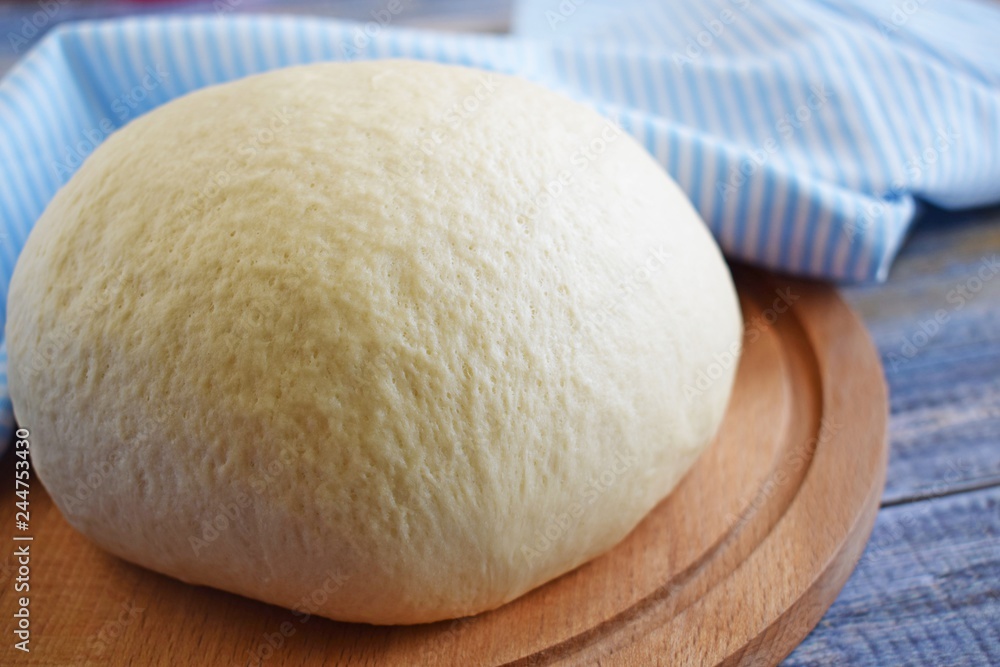 Dough for making delicious cinnamon buns on wooden background. Dough for making delicious cinnamon buns on wooden background.