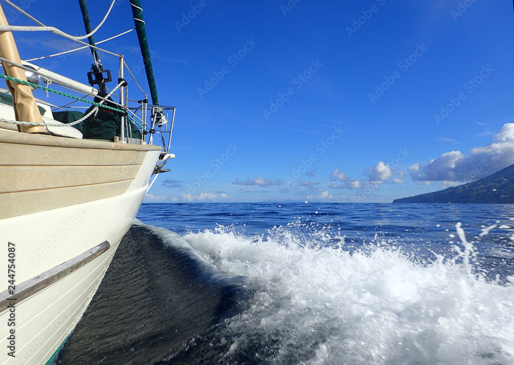 bow of a cream and light teak sailboat 