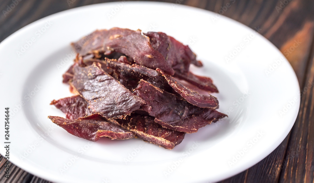 Beef jerky on the white plate Beef jerky on the white plate