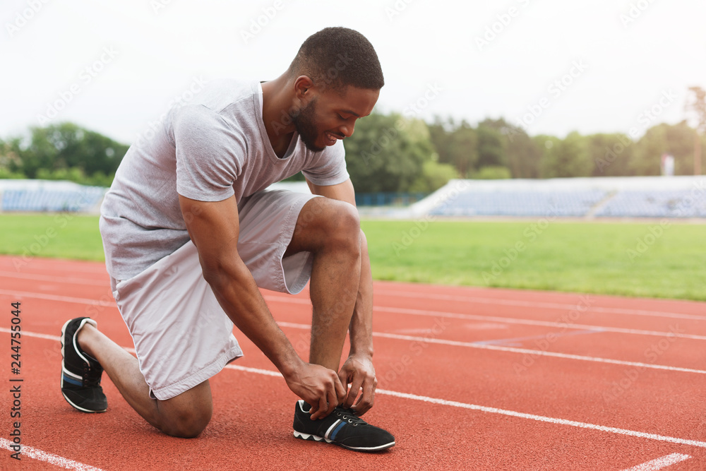 Runner tying running shoes laces.