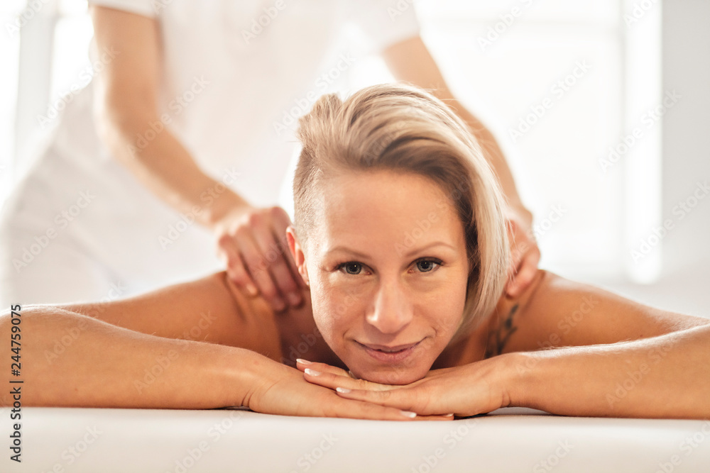 A Woman enjoying spa treatment at salon with masseur worker A Woman enjoying spa treatment at salon with masseur worker