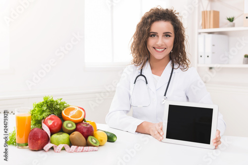 Doctor nutritionist holding blank digital tablet, mockup