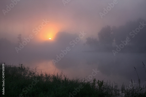 The sun rises early in the morning in the fog