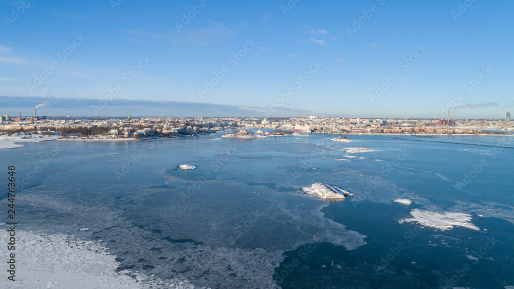Beautiful aerial panorama of Helsinki city at winter season. View from the sea. Blue sky.