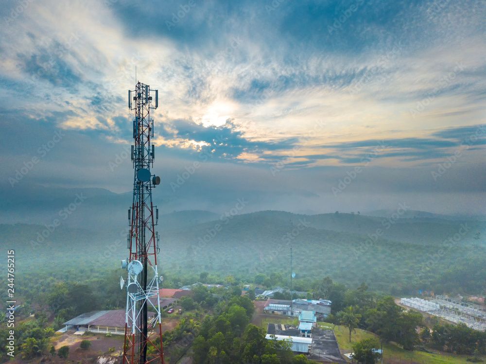 Obraz premium Aerial view of telecommunication tower with sunrise background.