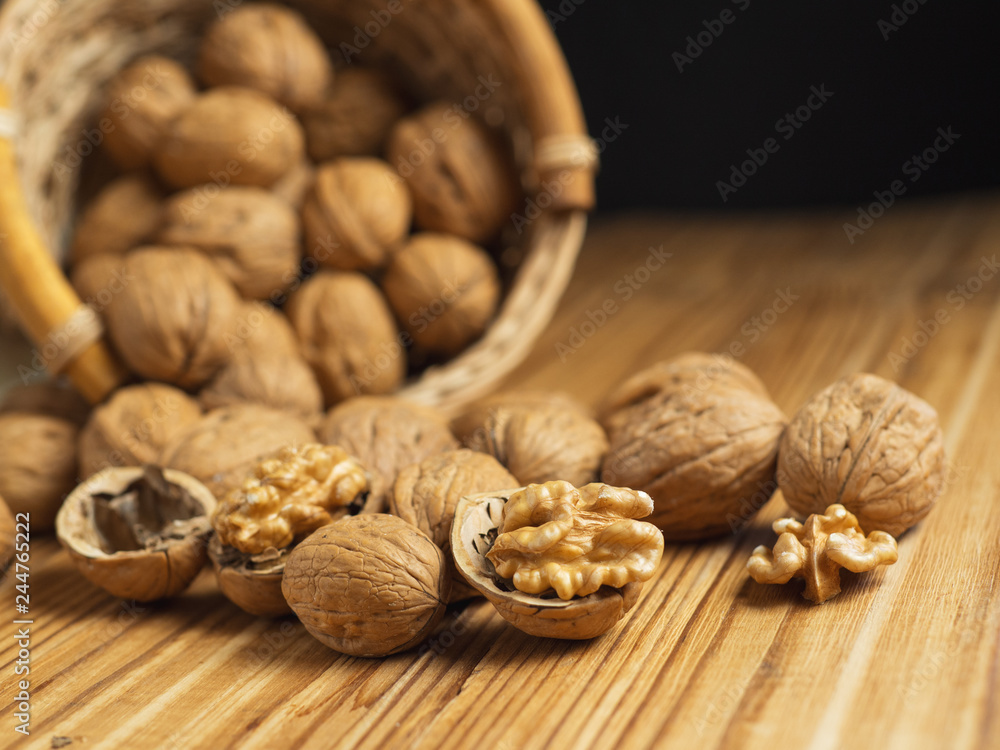 Walnut on a wooden table in a wicker basket Walnut on a wooden table in a wicker basket