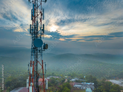 Aerial view of telecommunication tower with sunrise background.