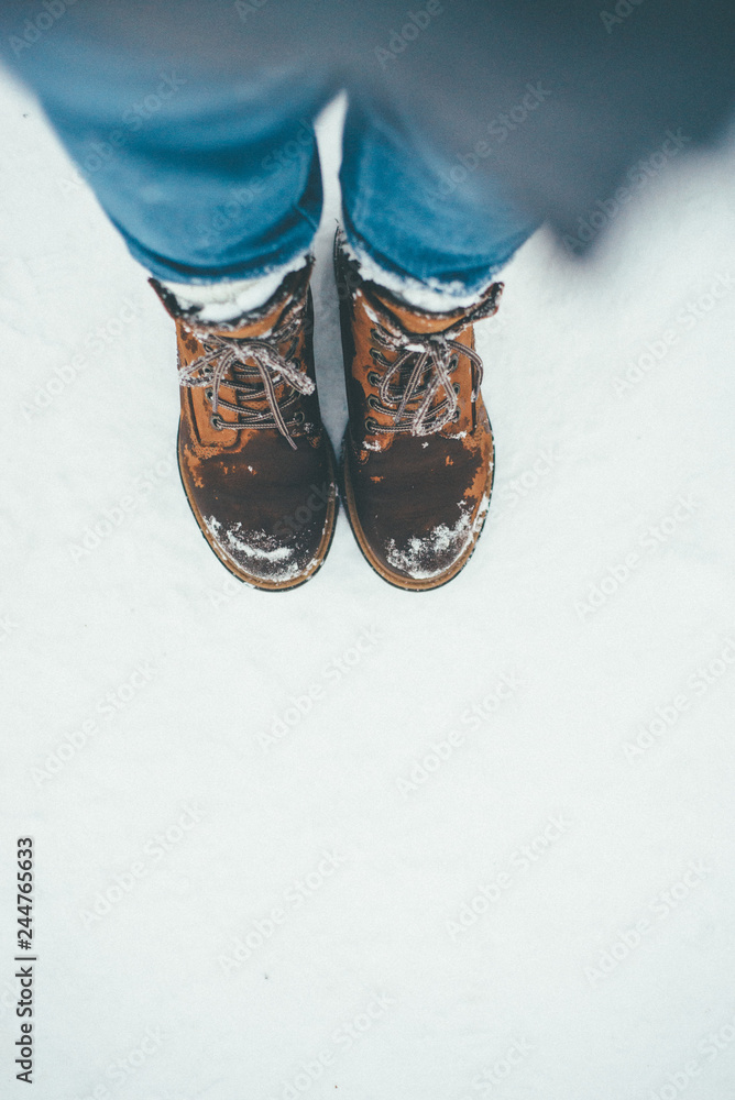 Brown shoes on the snow closeup