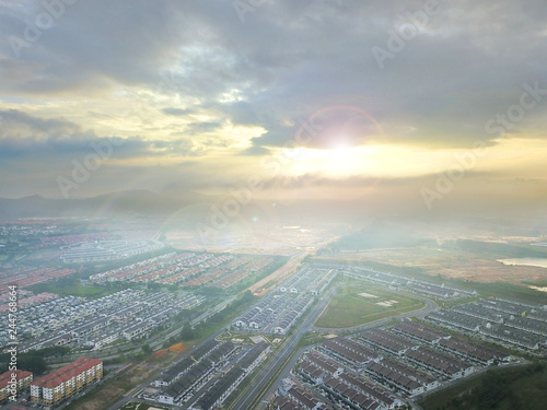 Aerial view of residential landed early morning with sun flare.