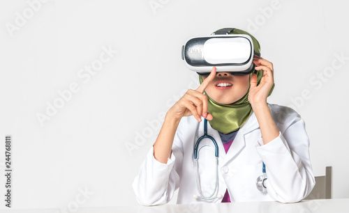 Veiled teenager wearing VR (virtual reality) box with white background. Medical conceptual.