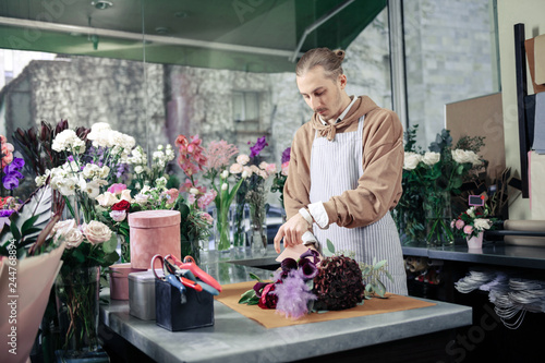 Valokuva Serious stylish floral designer working in luxury boutique