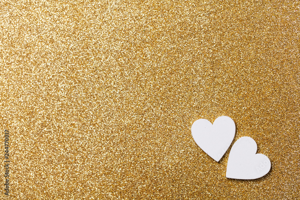 White heart shape on a golden glitter backgrond White heart shape on a golden glitter backgrond