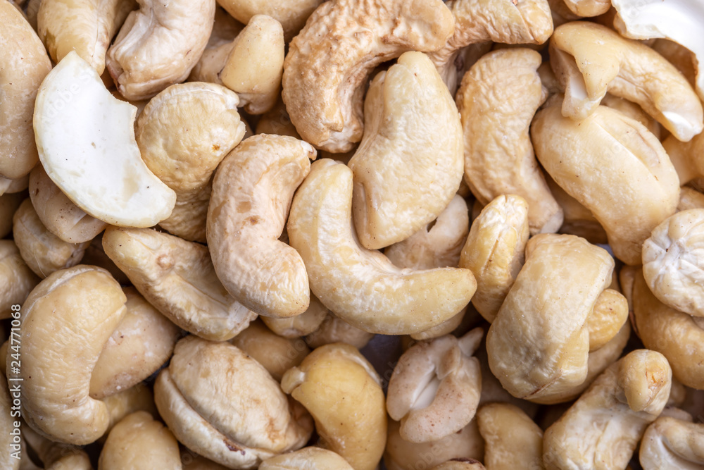 Fototapeta premium Tasty cashew nuts as background, top view