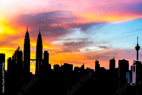 KUALA LUMPUR, MALAYSIA - DEC 6, 2015: Silhouette building of KLCC Twin Towers with orange sunrise background with natural lighting.