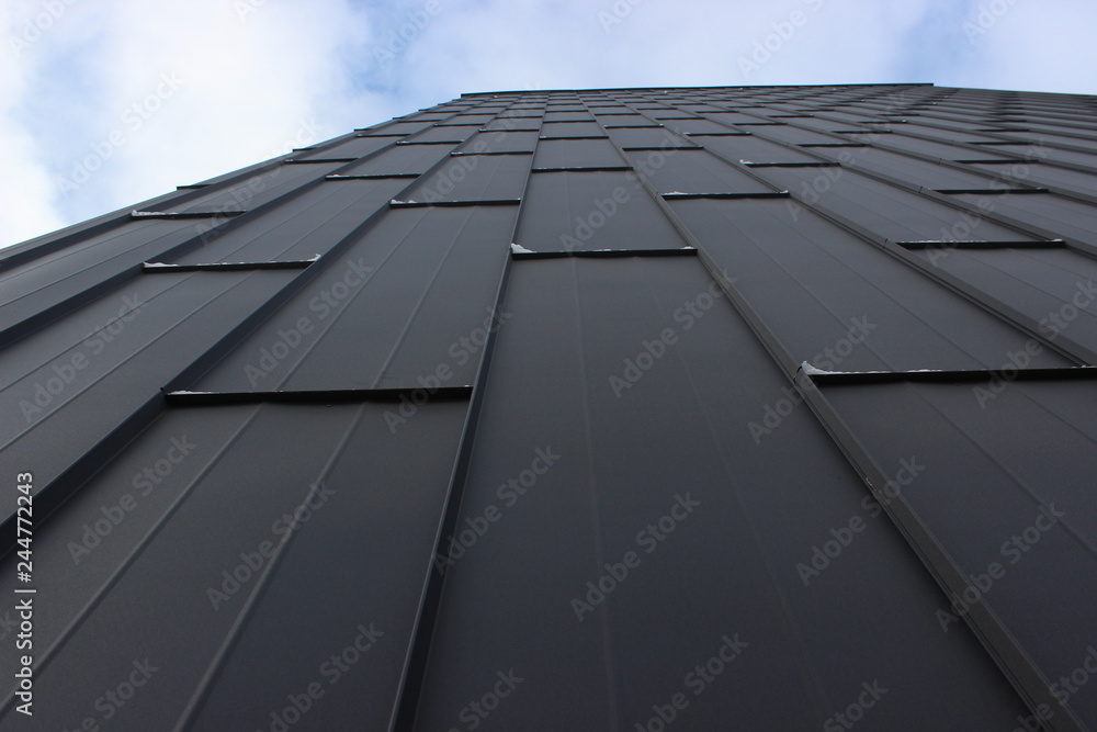the texture of iron sheets, the prospect of the sky. the modern decor of the facade, background the texture of iron sheets, the prospect of the sky. the modern decor of the facade, background