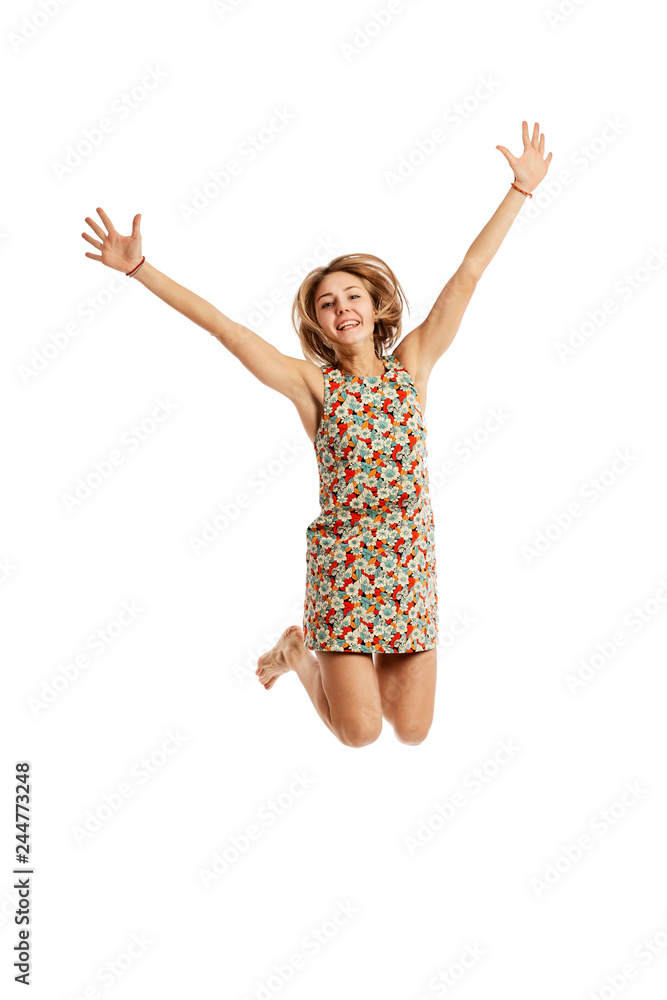 Cute smiling young woman in a jump, isolated on white background