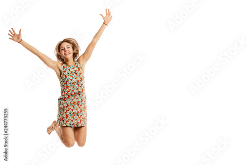 Cute smiling young woman in a jump, isolated on white background, copy space