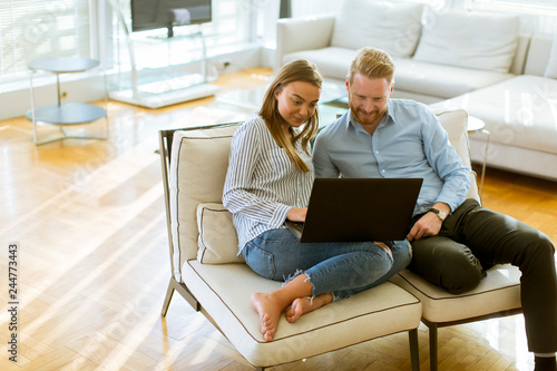 Couple using laptop in the ...