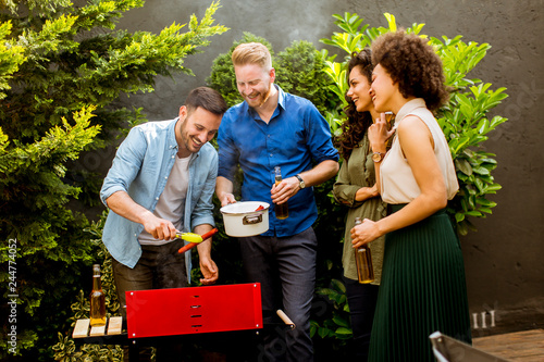 Happy friends grilling food...
