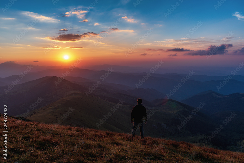 man is watching sunset in the mountain