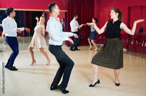 Positive people dancing twist in pairs