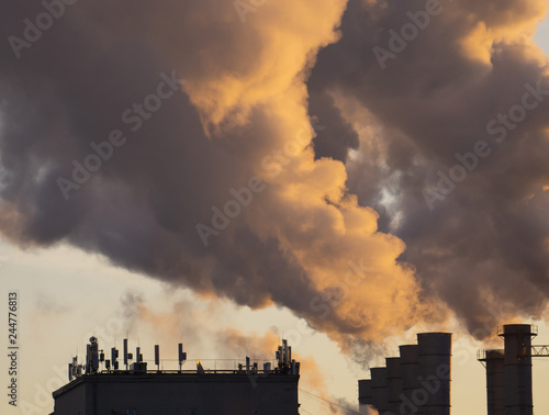 The smoke from the chimney on the background of the sky close-up, texture, residential buildings