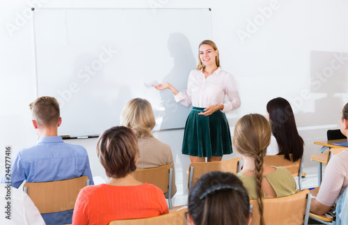 Young female teacher lecturing to students © JackF