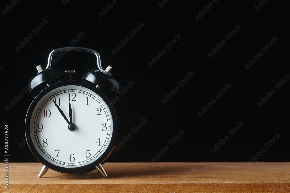 Clock shows five minutes to twelve Clock shows five minutes to twelve