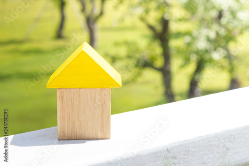 Wooden block on white table, building home concept.