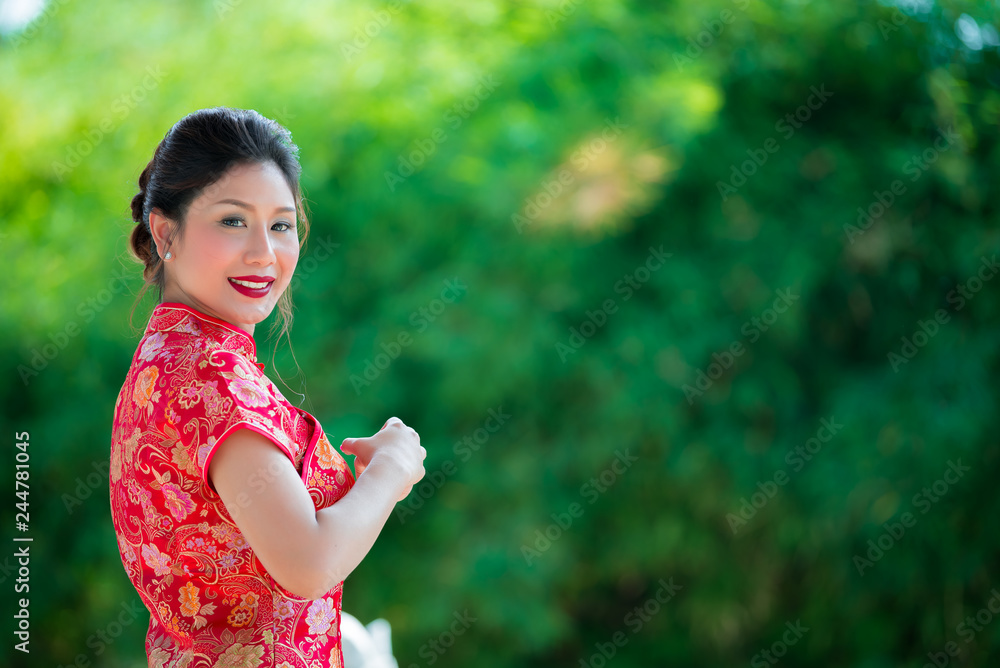 Portrait of beautiful asian woman in Cheongsam dress,Thailand people,Happy Chinese new year concept Portrait of beautiful asian woman in Cheongsam dress,Thailand people,Happy Chinese new year concept