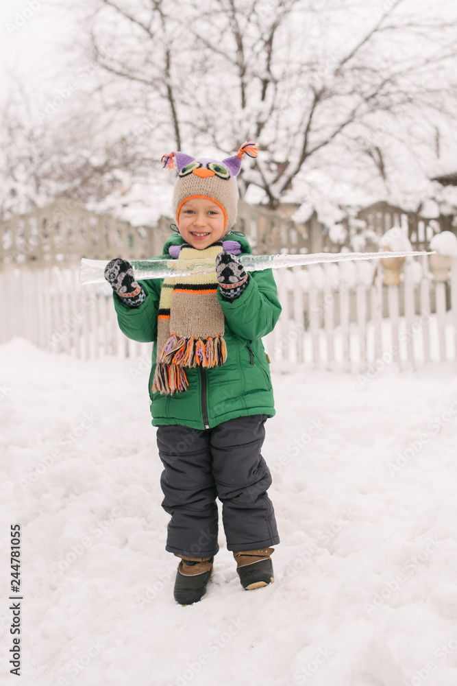 winter portrait of a little boy with an icicle winter portrait of a little boy with an icicle