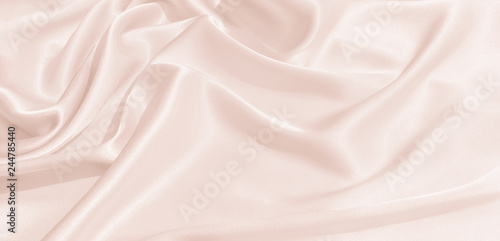 The texture of the satin fabric of pink color for the background