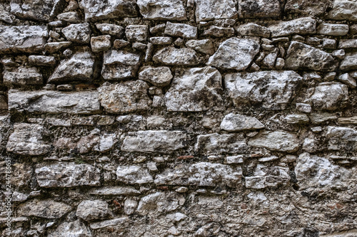 Stone wall background, dark grey limestone texture