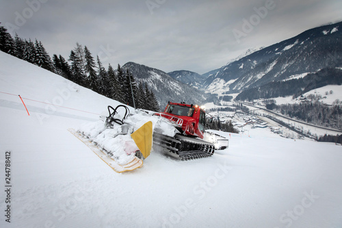 snow groomer on ski slope